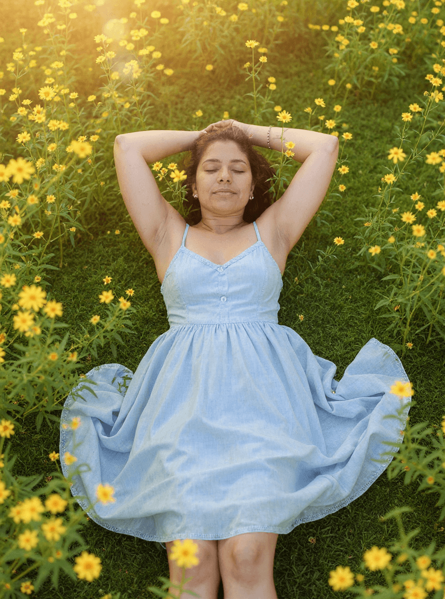 AI generated: A woman, viewed from above, sleeps peacefully with her arms above her head in the field of yellow fl...