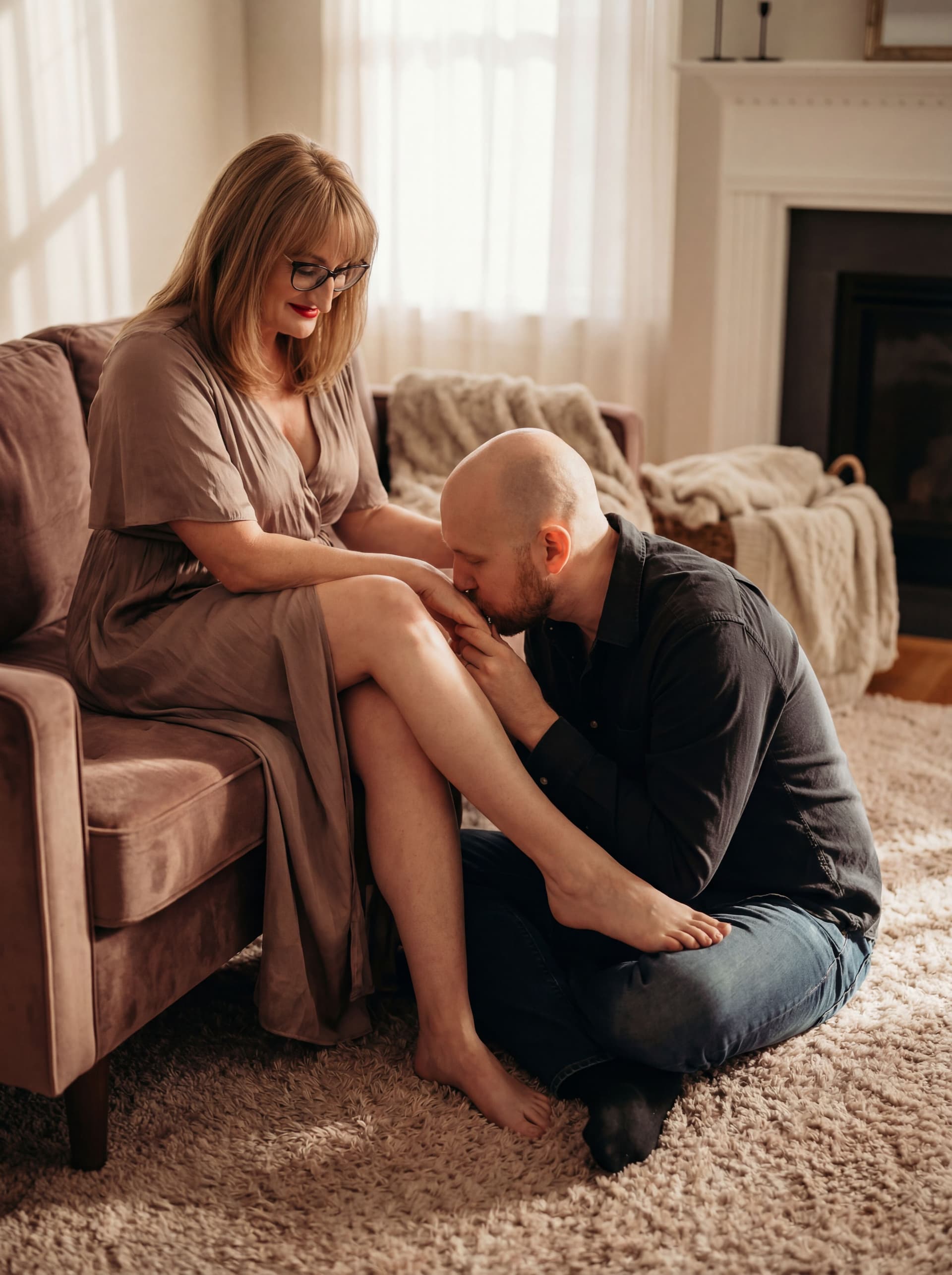 AI generated: A romantic, artistic scene of a couple — man gently kissing wife’s foot — in soft lighting , respect...