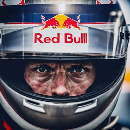 AI generated: DEA close up from a racecar driver in a race adrenaline, RED BULL, sharp eyes, serious, focused, sur...