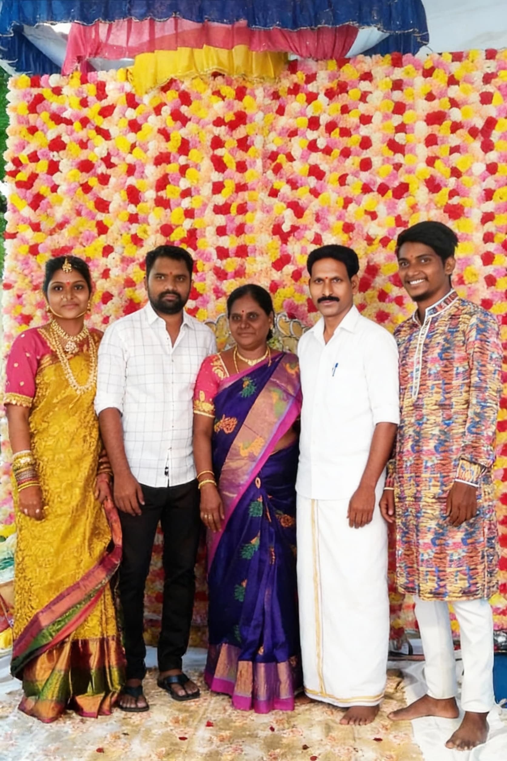 AI generated: Recreate a image of a family adding a man in between of a group photo he wearing white kudutha make ...