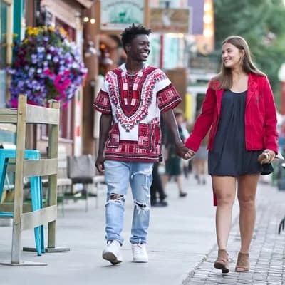 AI generated video: the camera moves back as the subjects walk slowly towards it