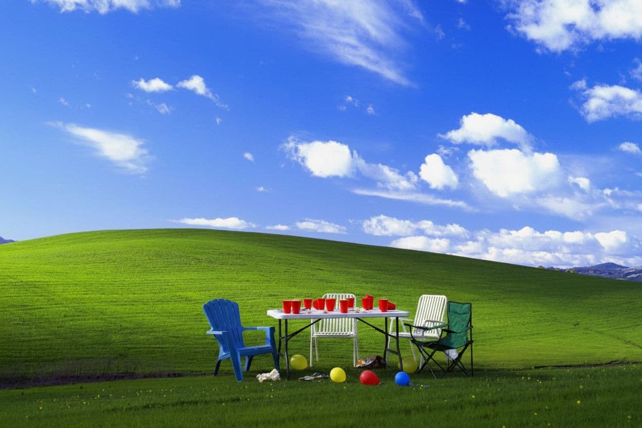 AI generated: Add a small realistic outdoor setup that looks like the remains of a casual party: a simple folding ...