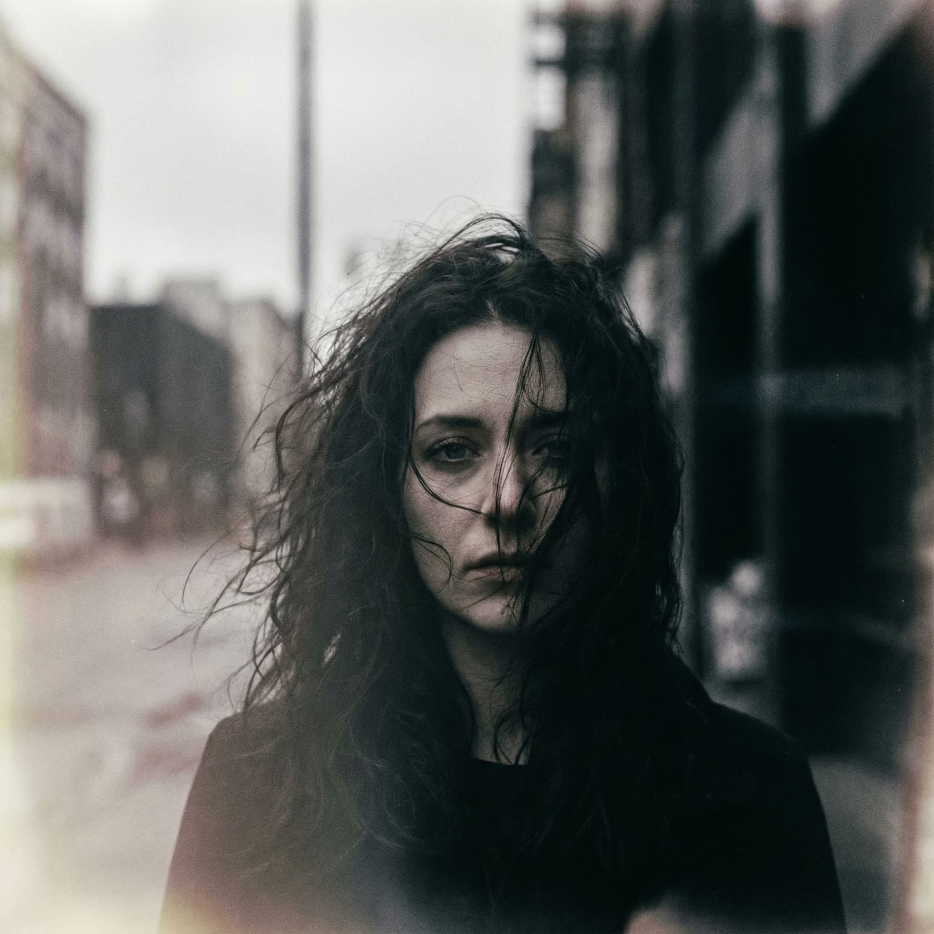 AI generated: a woman with long wild hair on a windy day, in the style of toy camera effects, haunting elegance, f...
