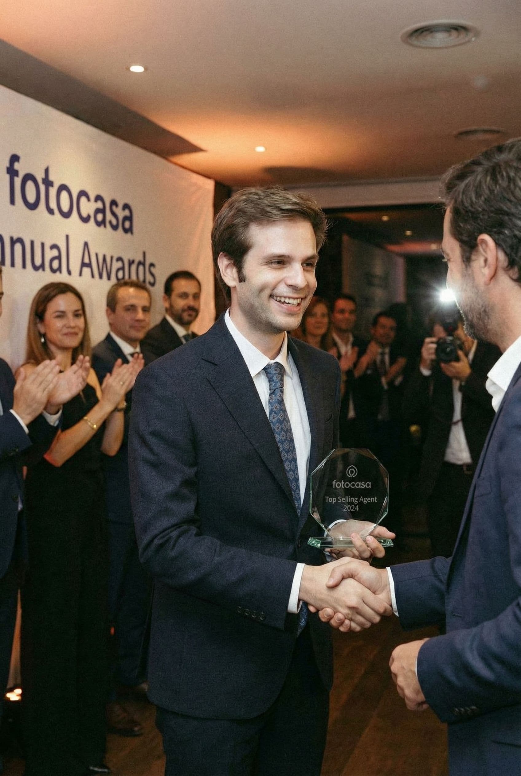 AI generated: The man is the top selling real estate agent of Fotocasa