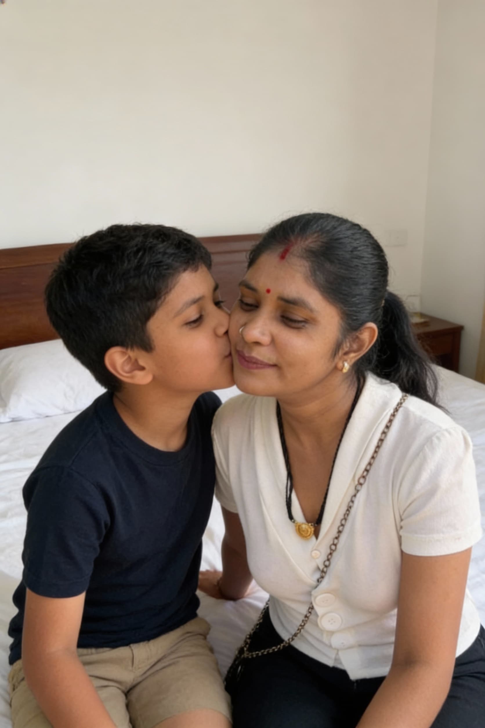 AI generated: The women sitting with boy on bed,the woman kiss the boy chiks 