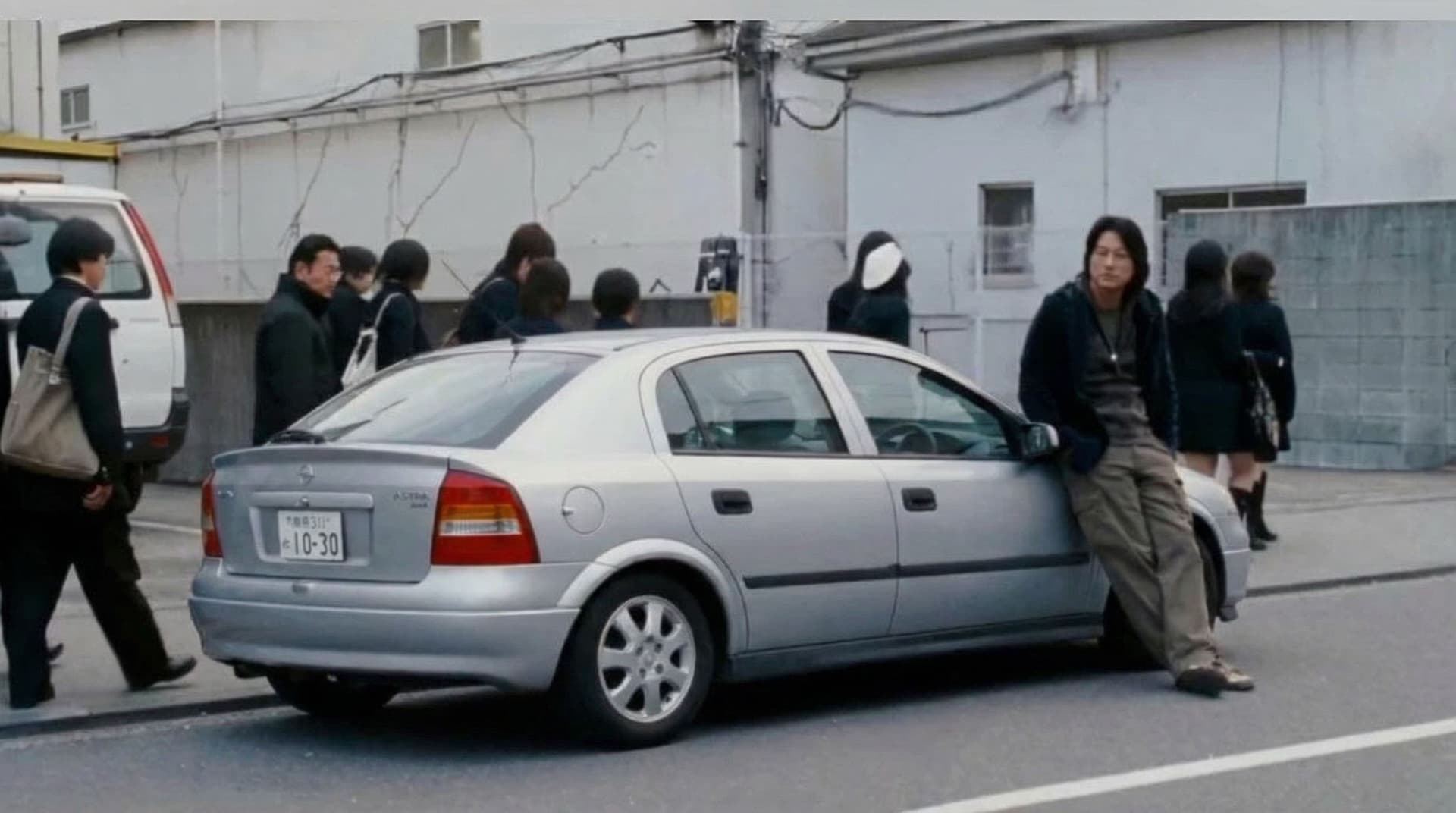 AI generated: change the car in this image to a silver 2001 opel astra hatchback 
