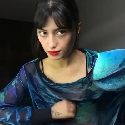 AI generated video: camera pans out quickly, she  removes her top is completly topless naked and reveals her big saggy b...