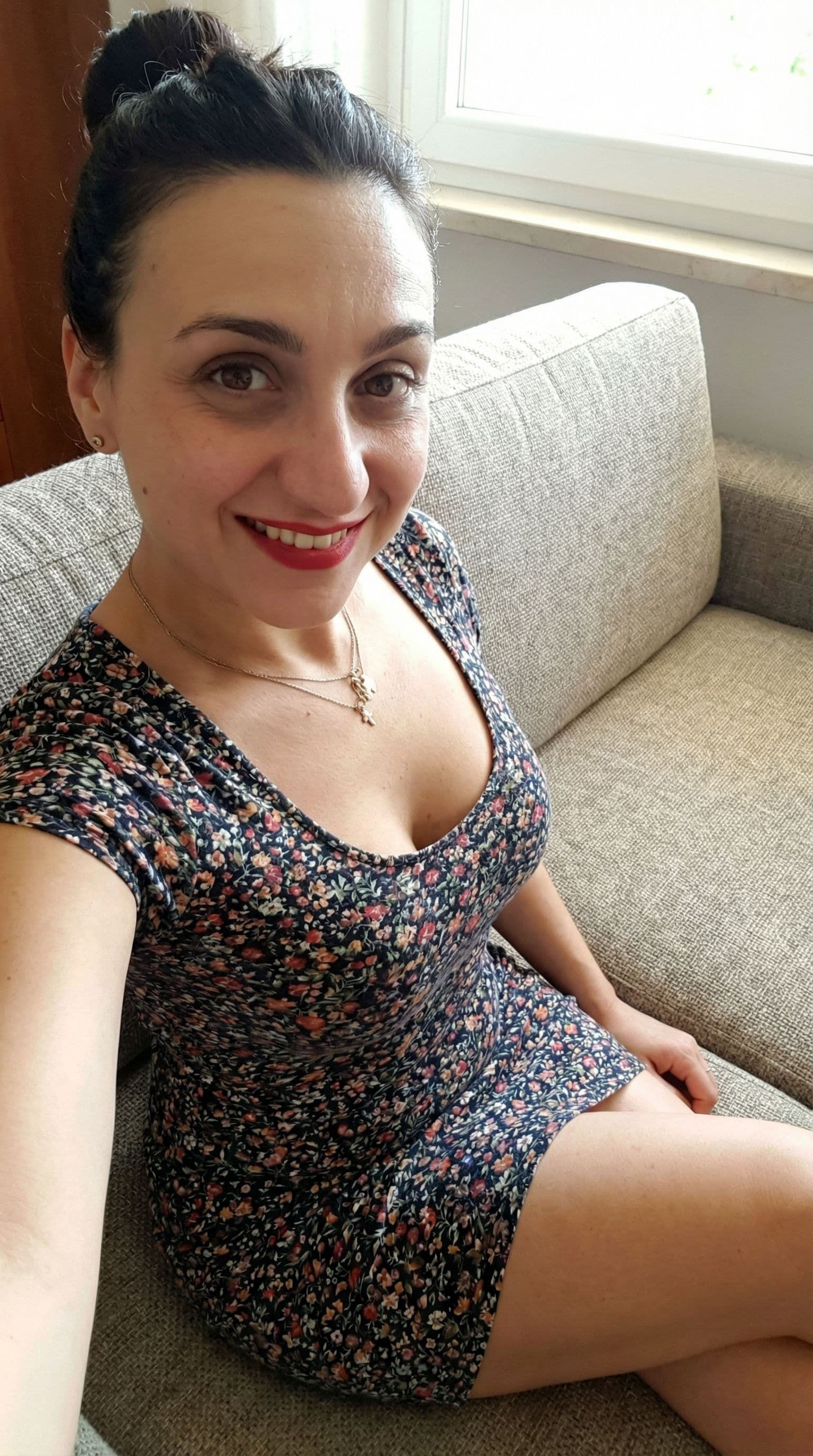 AI generated: Wearing a mini dress, sitting on a couch,, close view, 35-year-old , busty body, 