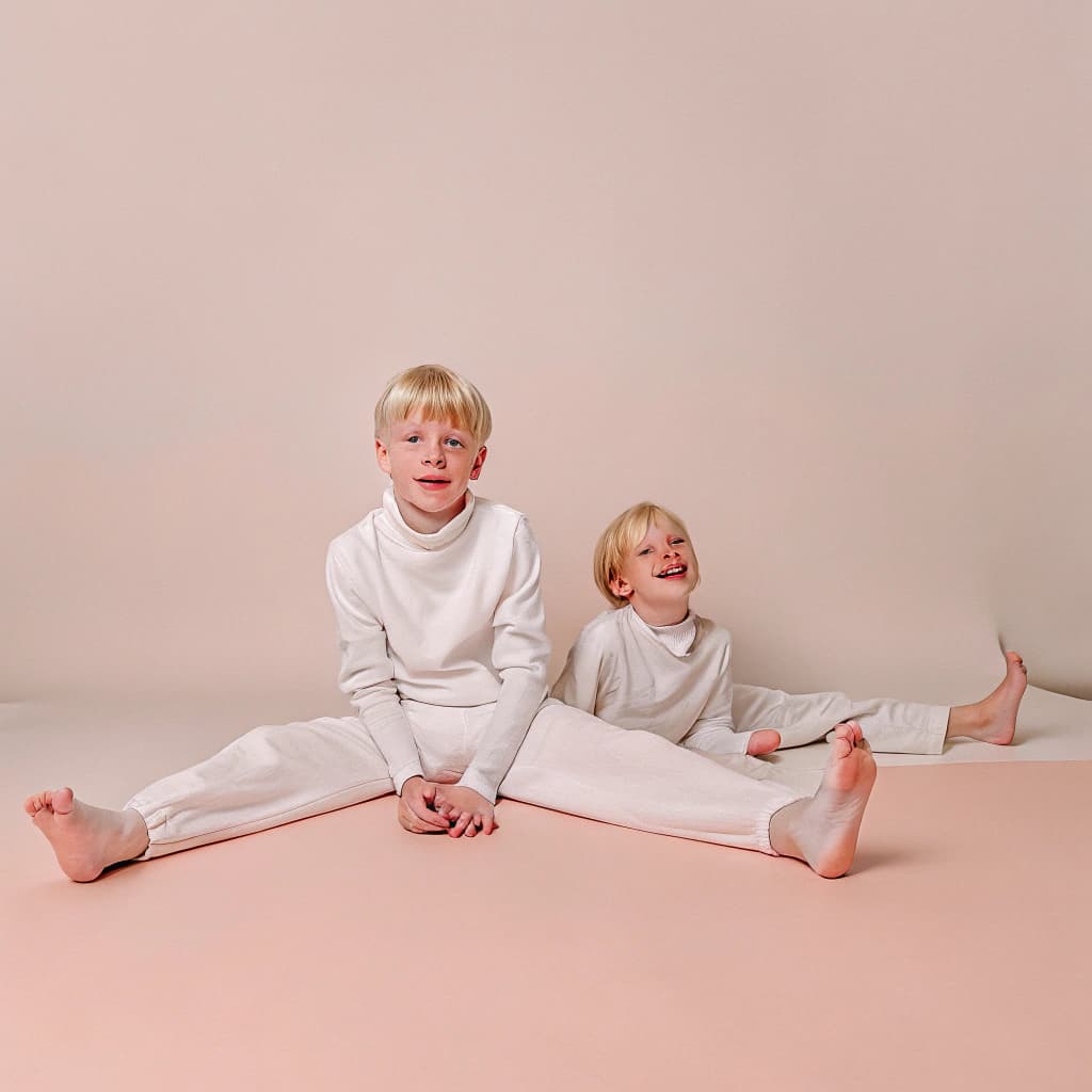 AI generated: Two boys kid blond sitting down 