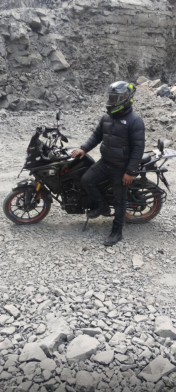 AI generated: Added this guy on this bike wearing black Northface jacket, black jeans and black shoes.