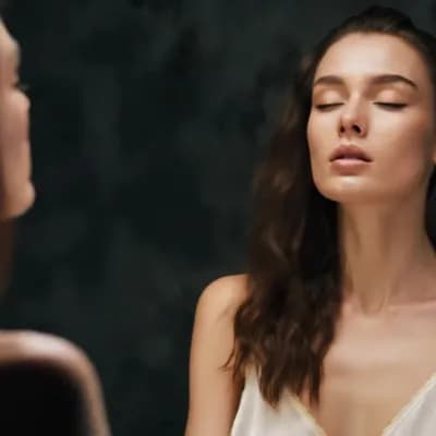 AI generated video: A stunning woman in her late 20s, ethereal beauty, wearing a night dress that catches the neon light...