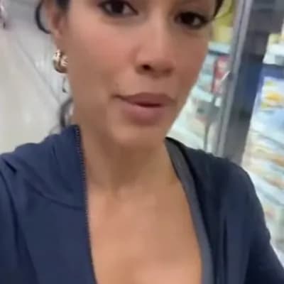 AI generated video: A realistic cinematic smartphone selfie video of a confident woman shopping in a supermarket. She’s ...