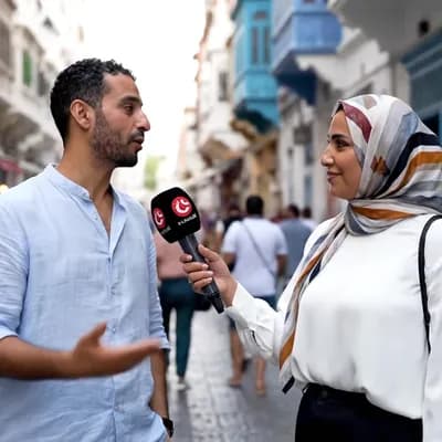 AI generated video: A Tunisian man being interviewed by a Tunisian woman in the streets of the Capital Tunis.