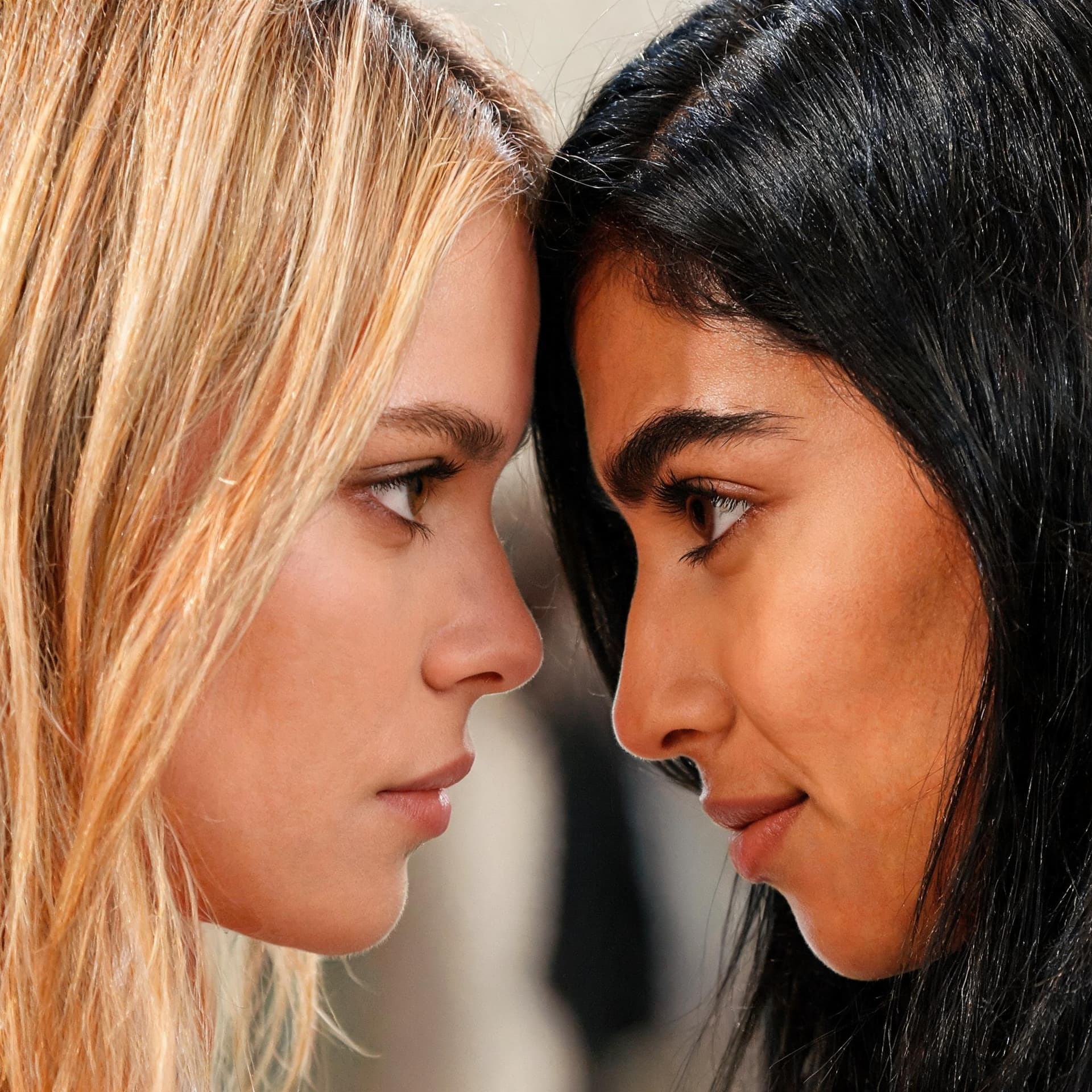 AI generated: blonde look directly into the mexican raven haired beauties brown eyes with confidence

