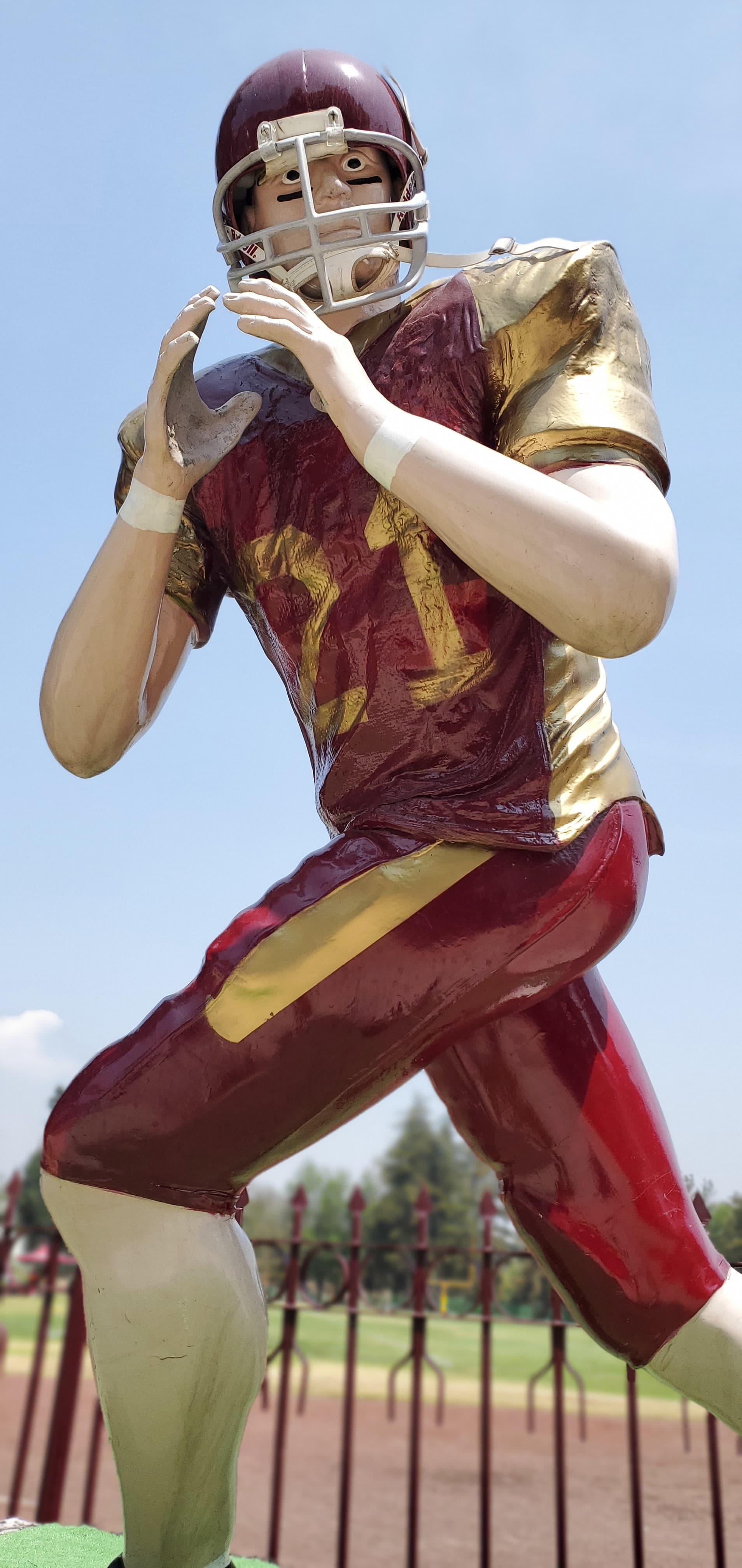 AI generated: Football player, using 21 number jersey, red and gold uniform