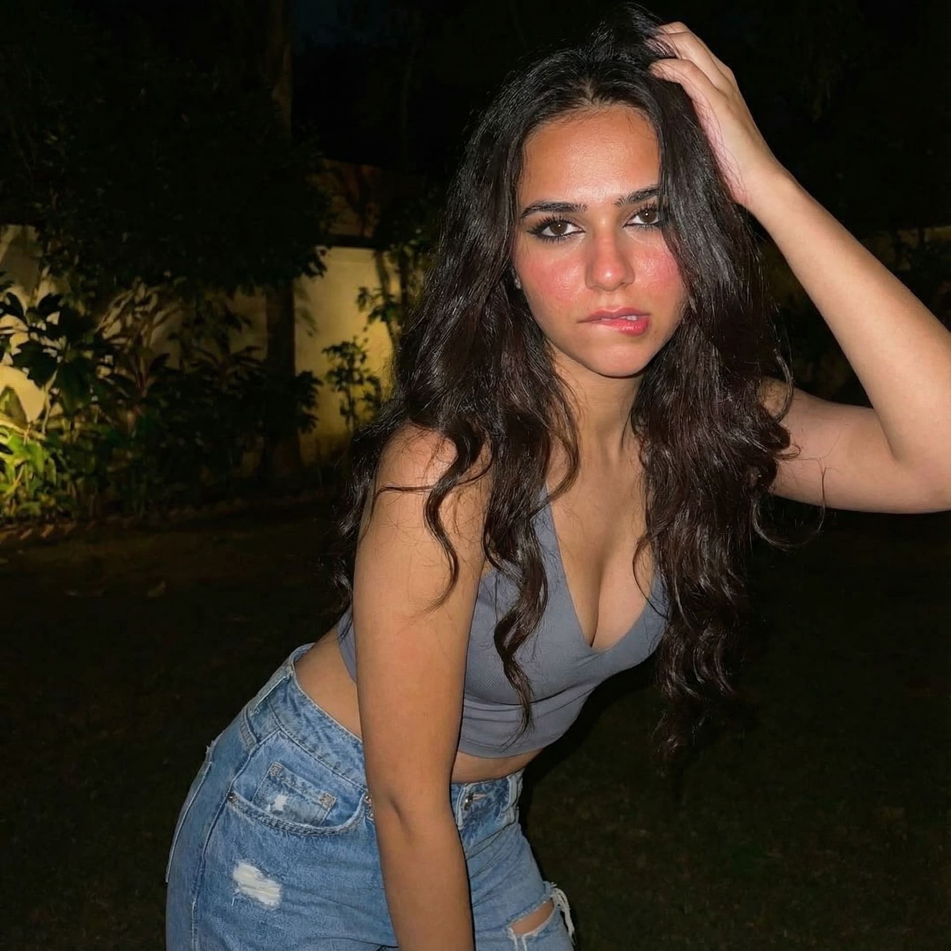 AI generated: A stunning seductive Egyptian/Arabic young woman resembling Yostina, long wavy dark hair, tanned ski...