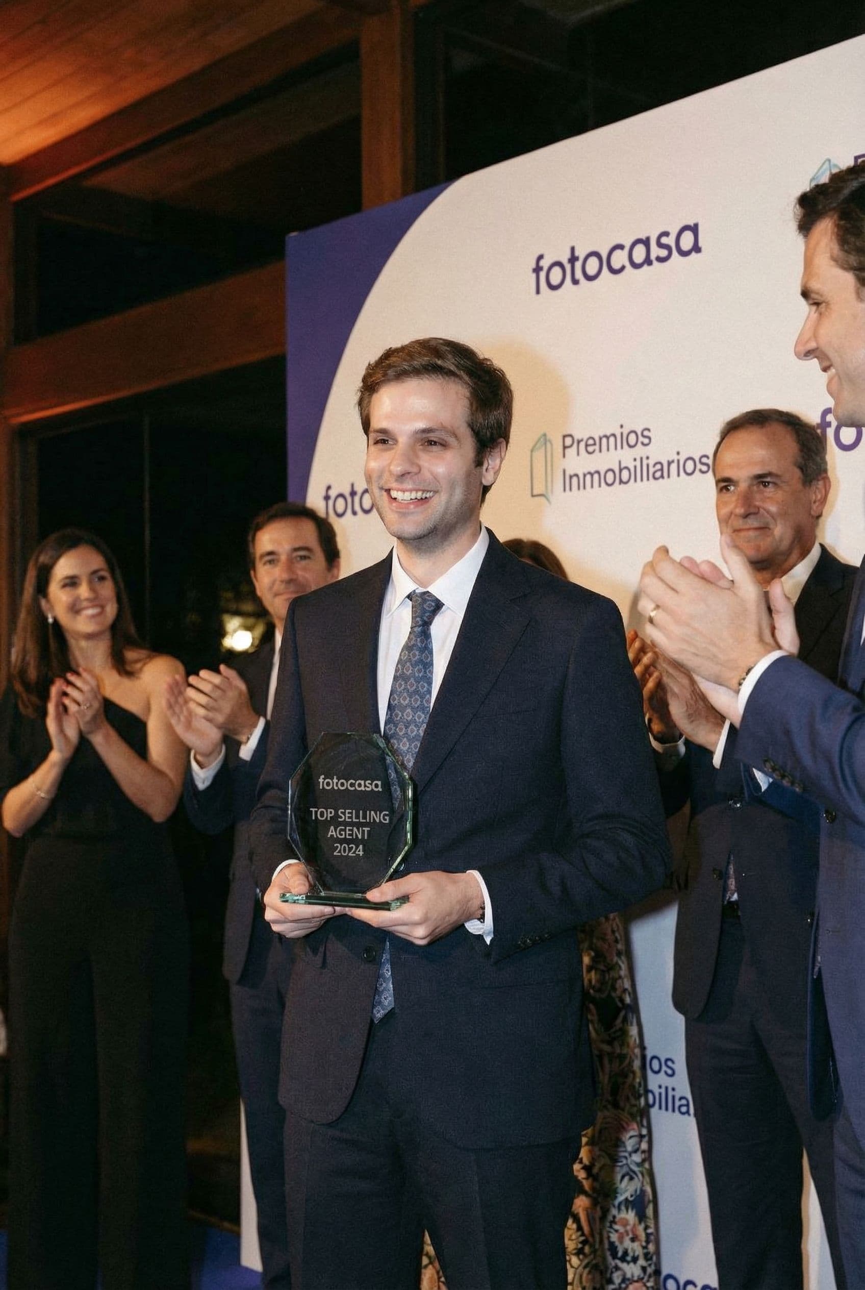 AI generated: The man is the top selling real estate agent of Fotocasa