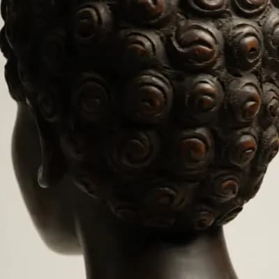 AI generated video: An African American female head made with carved wood
