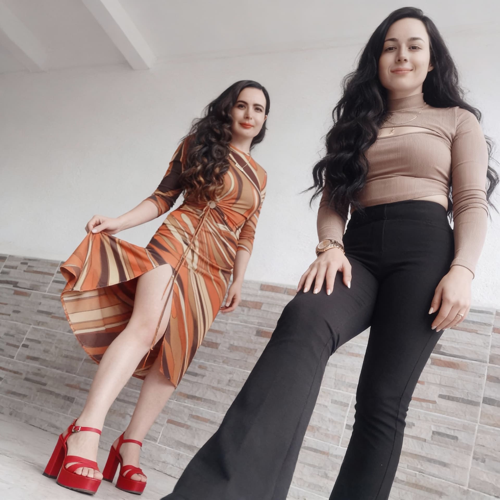 AI generated: Two women are in a room. They stand up. The woman in the orange dress is wearing red high-heeled pla...