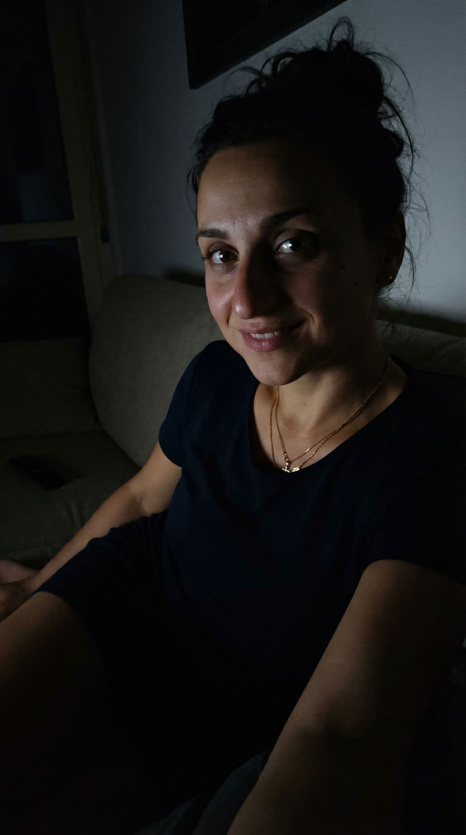 AI generated: Wearing a mini dress, sitting on a couch, close view, 35-year-old , busty body, at night no lights, ...