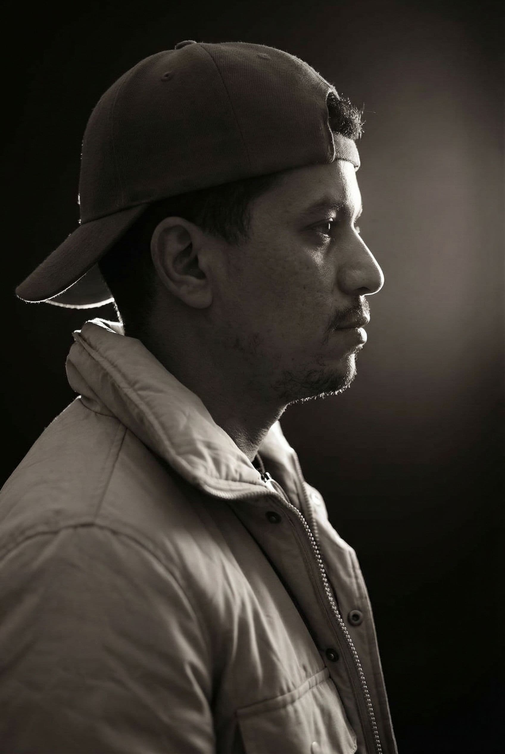 AI generated: Can you make this A monochrome side-profile shot of me, with light highlighting the edges of his hai...