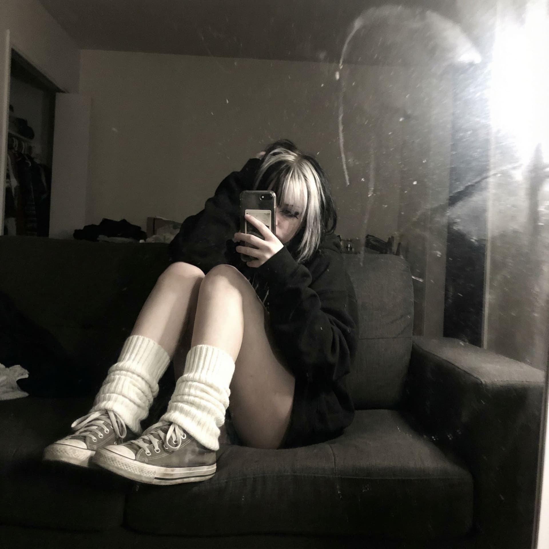 AI generated: An extremely unremarkable iPhone mirror selfie photo with no clear subject or framing—just a careles...