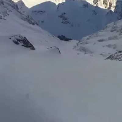 AI generated video: a first-person GoPro video of a snowboarder descending from a mountain after jumping out of a helico...