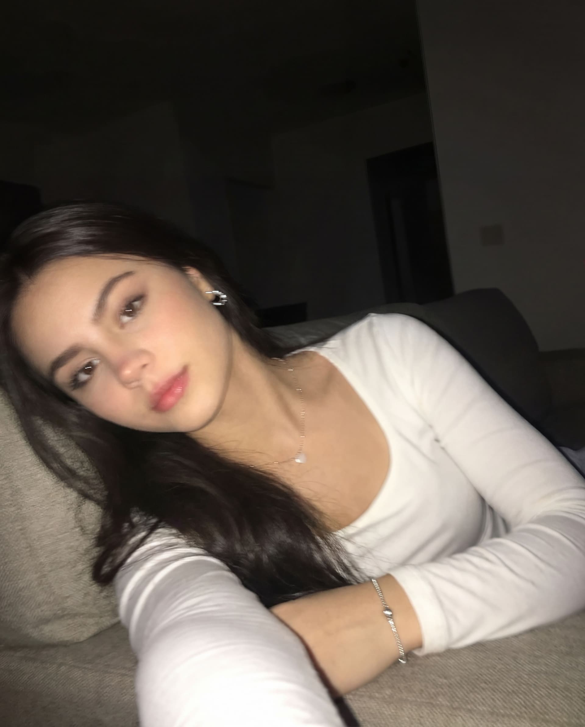 AI generated: Using the uploaded reference photo, create a standard iPhone selfie with flash. There's no clear sub...