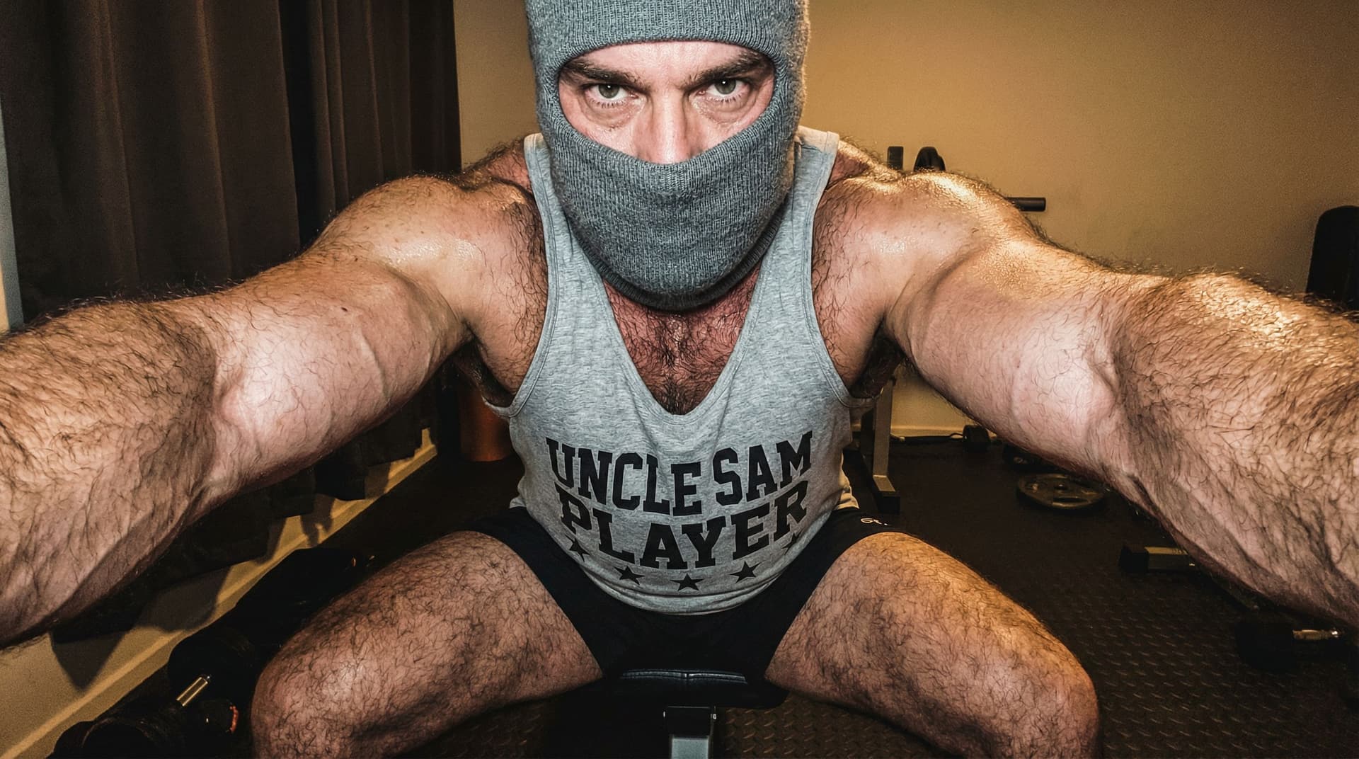 AI generated: hyperrealistic close-up gym portrait, rugged muscular man 40yo sitting on black bench press, wide st...