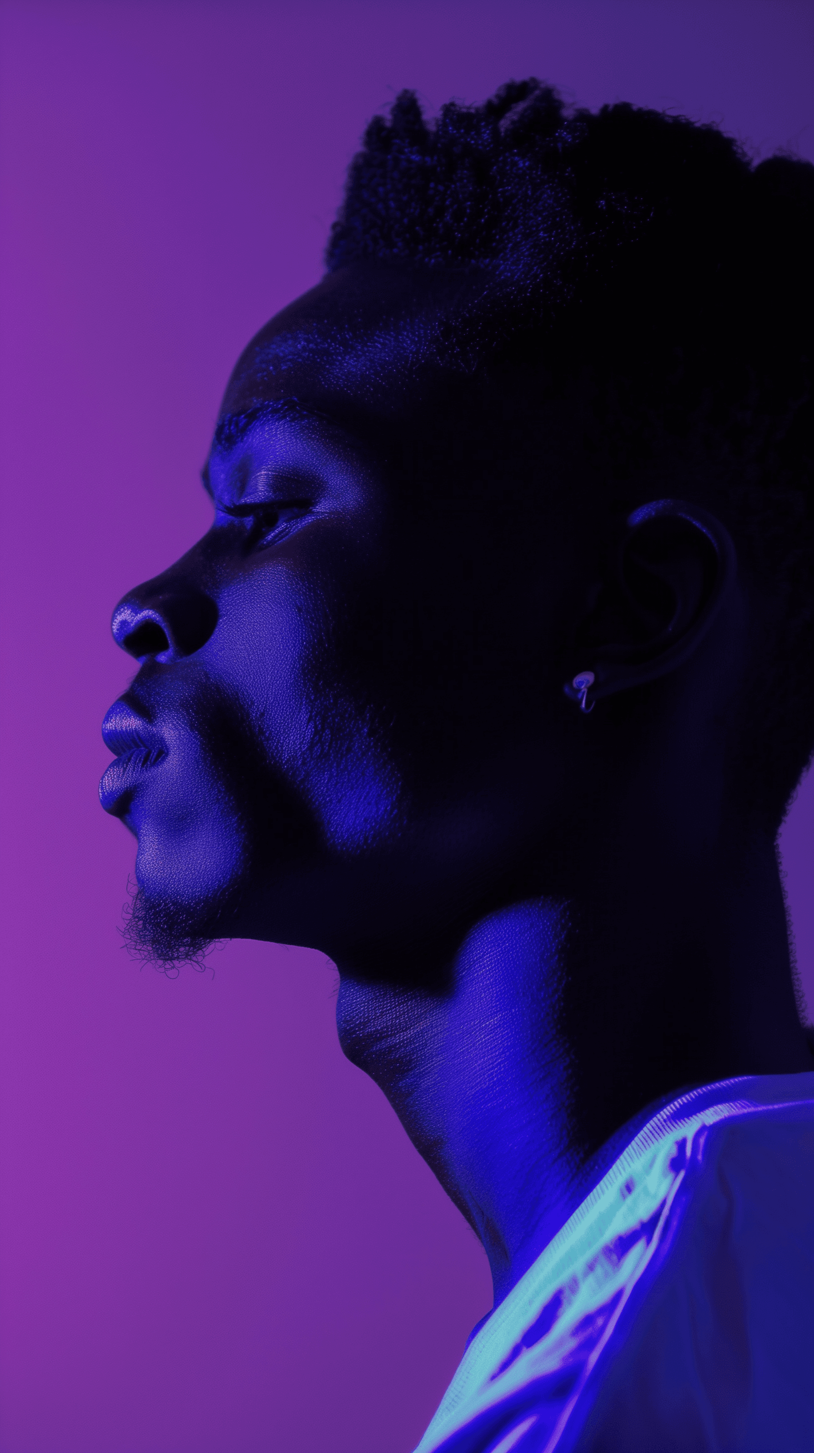 AI generated: side profile of a man under a luminescent indigo light, his features cast in sharp relief against th...