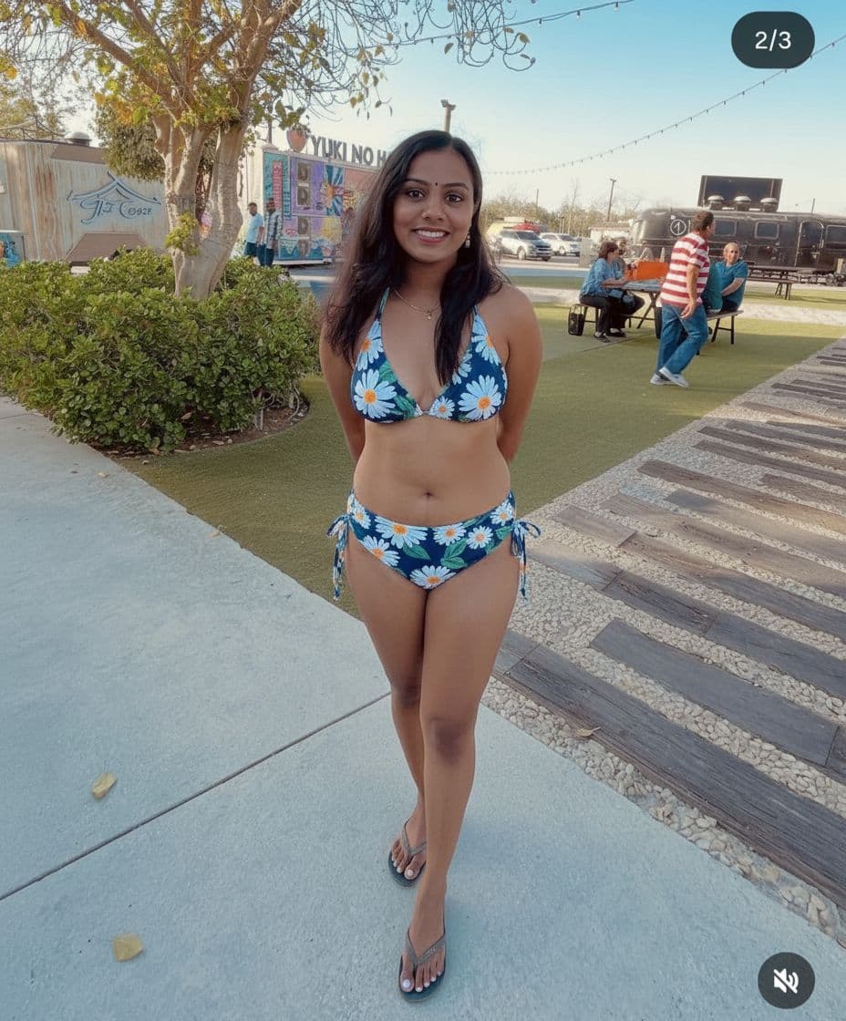 AI generated: Make her wear swimsuit with two pieces

