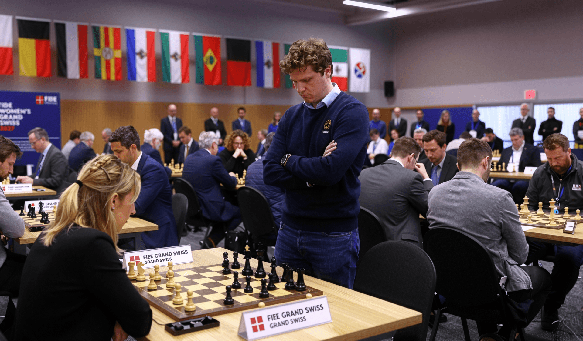 AI generated: A wide photograph captures the busy atmosphere of a professional chess tournament. In the foreground...