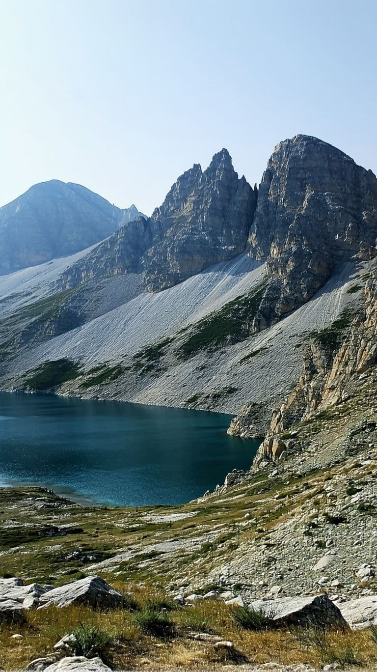 AI generated: The surrounding landscape is rugged and mountainous, with a body of water visible in the distance. T...