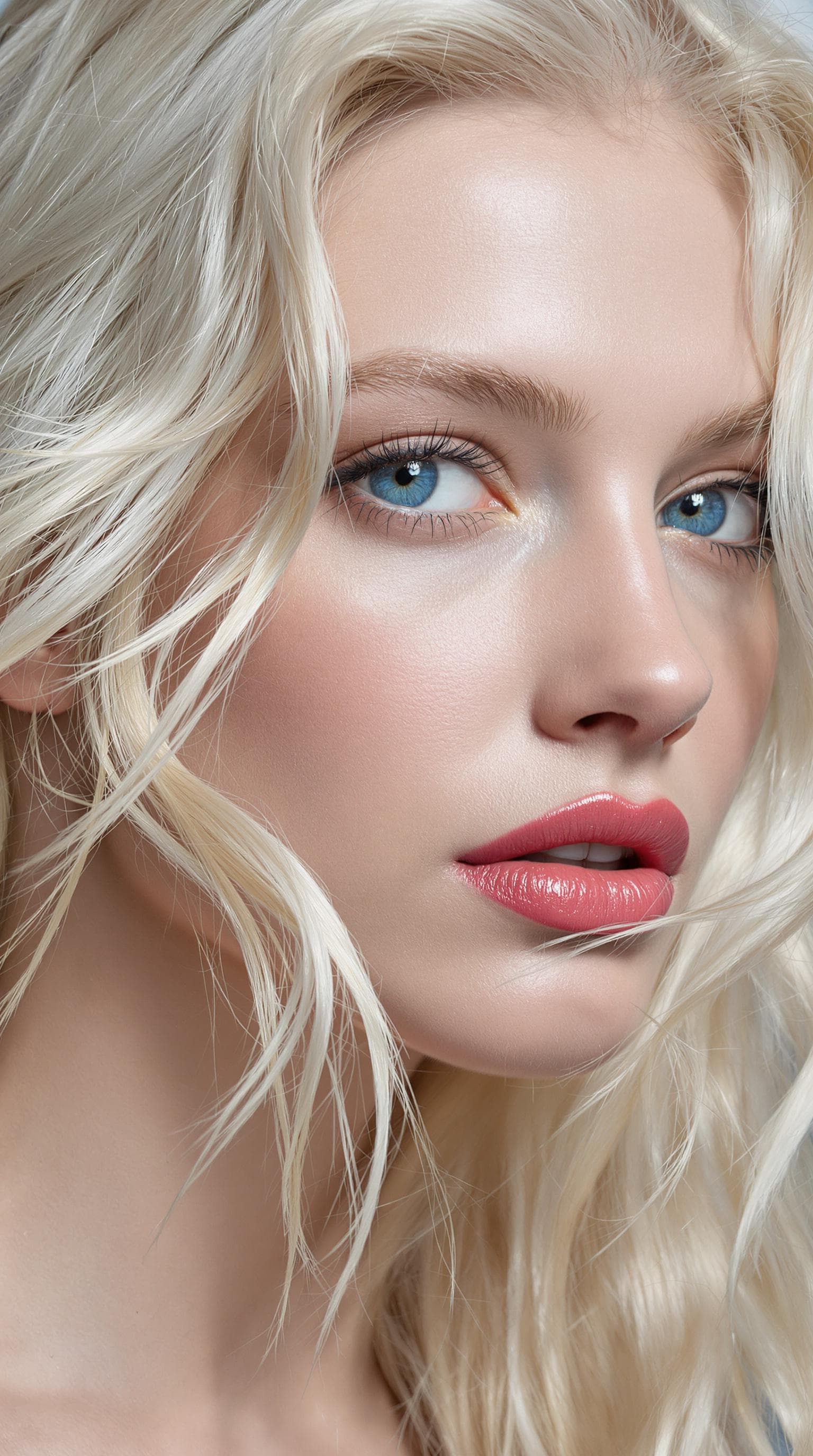 AI generated: "The image is a striking close-up portrait of a model with lustrous, tousled platinum blonde hair ca...