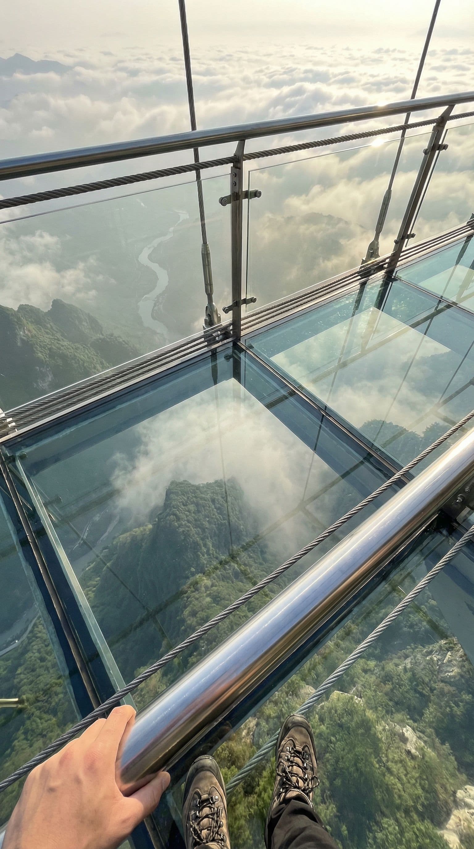 AI generated: First-person perspective (POV) or high-angle shot of a stunning, realistic glass bridge corridor sus...