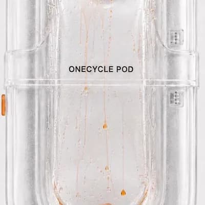 AI generated video: Animate only the orange roplets inside the transparent ONECYCLE POD. Keep the pod, label, digital ti...