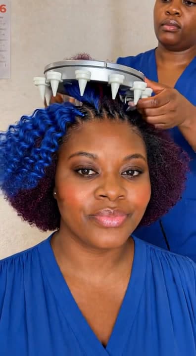 AI generated video: Using a very big automation braiding round machine on my client who have blue and wine colour hair f...