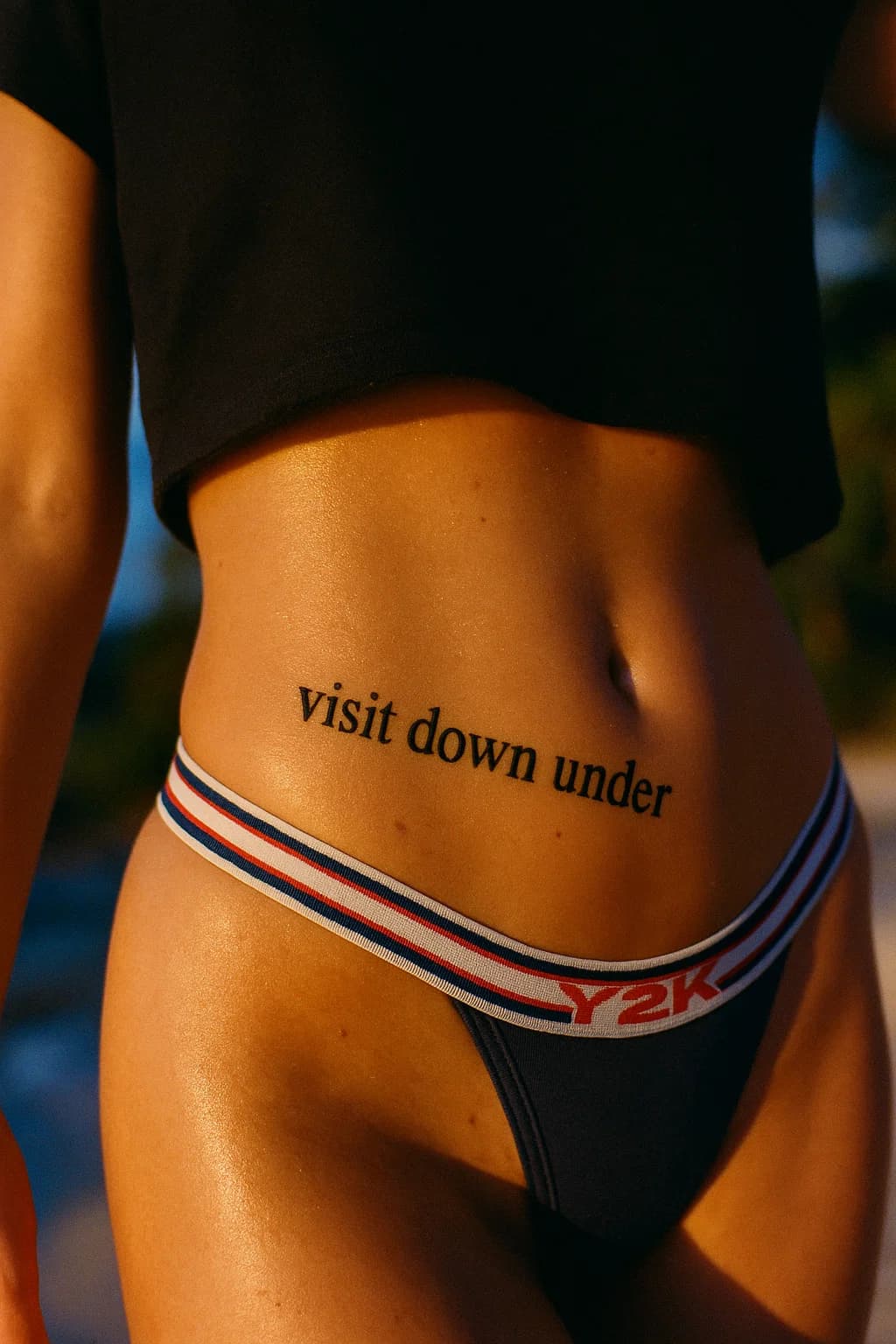 AI generated: A 1990s-erafaded photograph showing a close-up view of a woman's hip area wearing a black high cropp...