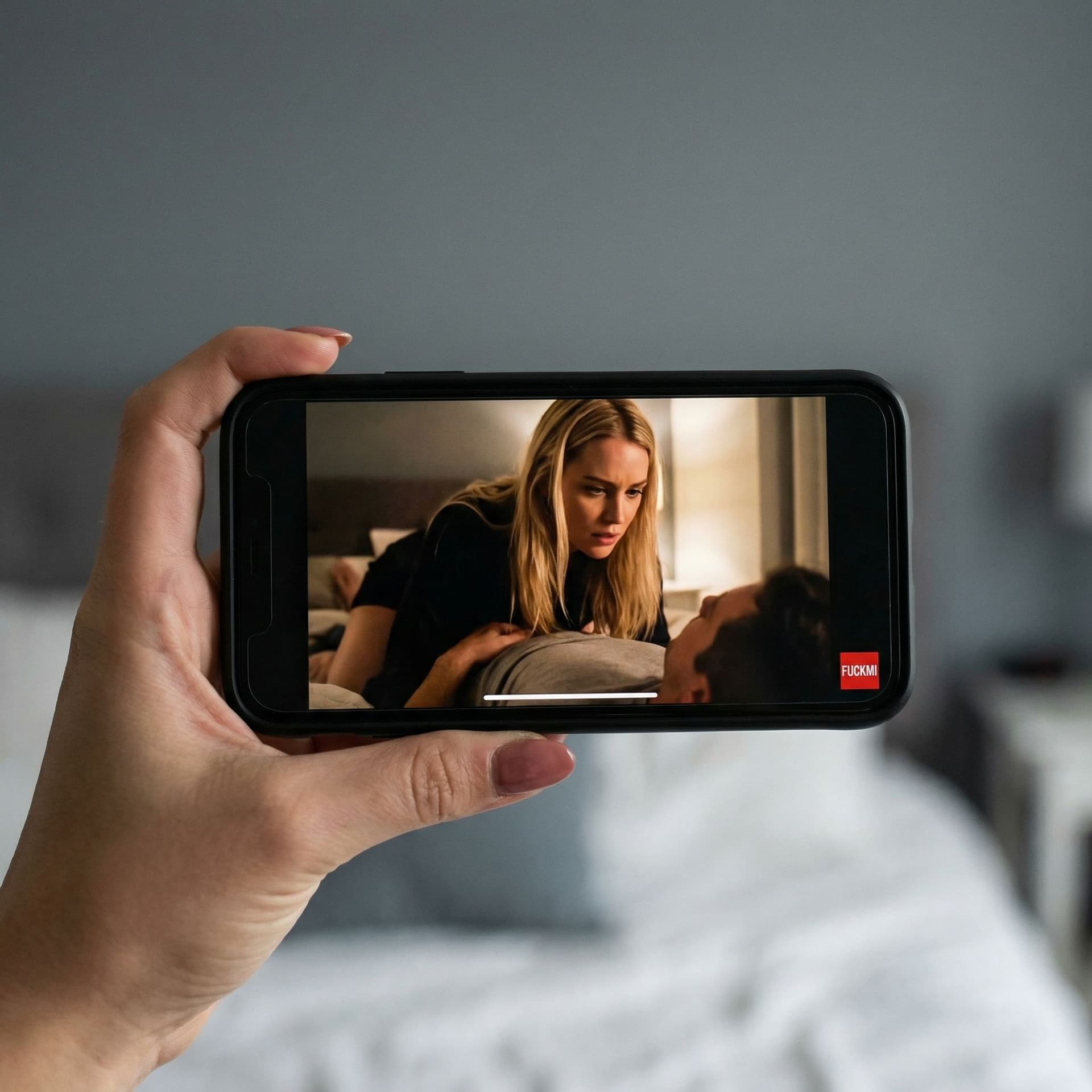 AI generated: The image: An extremely detailed close-up of a smartphone held in landscape view by the hand of the ...