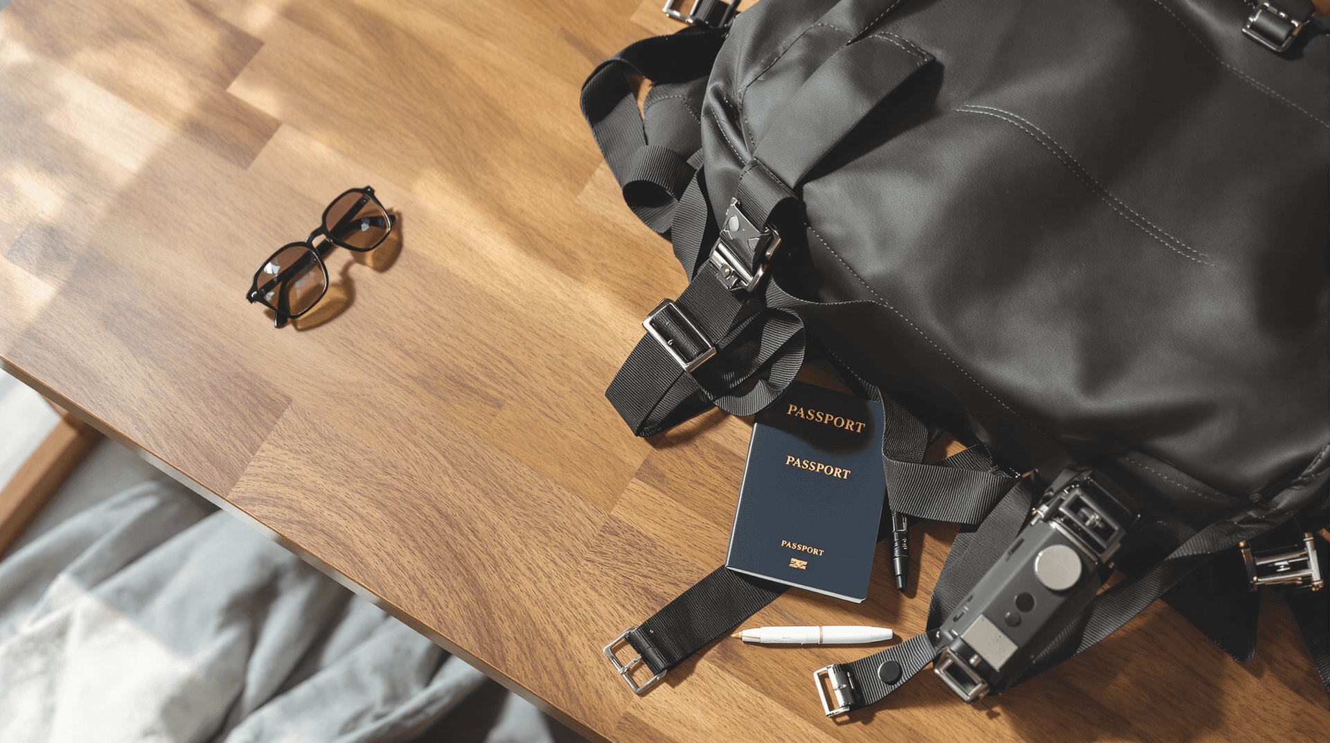 AI generated: A minimalist travel setup with a backpack, passport, and sunglasses on a wooden table, natural light...