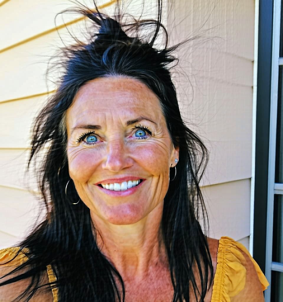 AI generated: Create an HDR photo of a woman. The woman has long, messy black hair pulled back and light blue eyes...