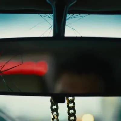 AI generated video: 	•	Slow zoom into a cracked rearview mirror with flickering neon signs in the background.
	•	Brief ...