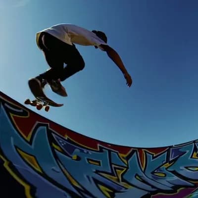 AI generated video: The camera locks onto a skateboarder as they roll toward the towering edge of a massive half-pipe. F...