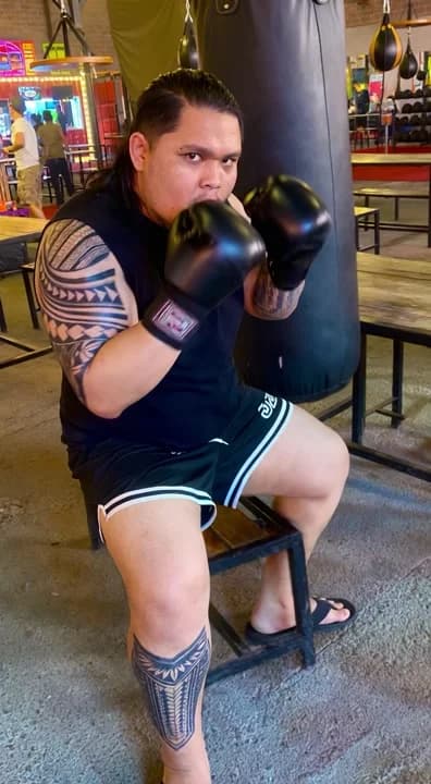 AI generated video: An athletic boxer in a professional gym, throwing a powerful, sweat-flying cross punch into a heavy ...