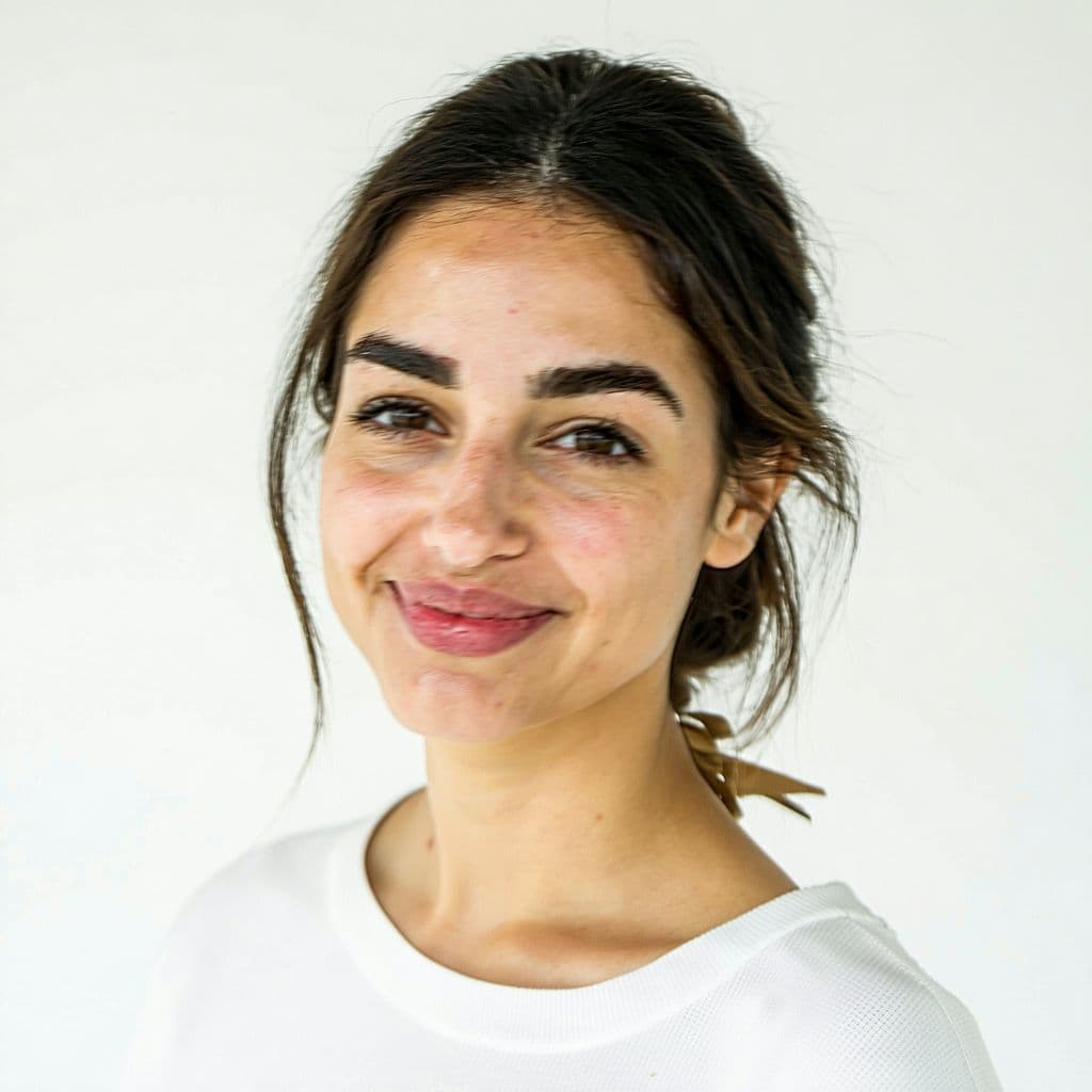 AI generated: young Turkish 30 years woman, gentle smile but don't show teeth, close shot, ((standing before the w...