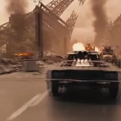 AI generated video: A post apocalyptic car race in front of the ruins of the Eiffel Tower. Cars speeding by, exploding a...