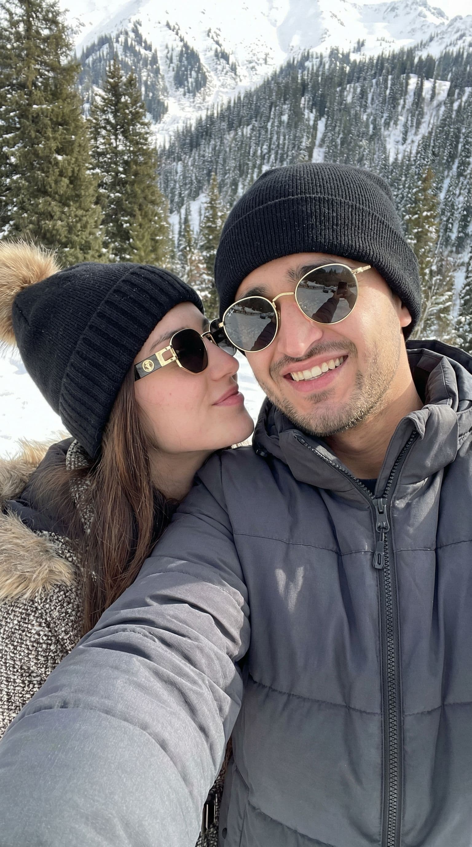 AI generated: 2-A high-quality, realistic winter selfie of a young couple standing very close together in a snowy ...