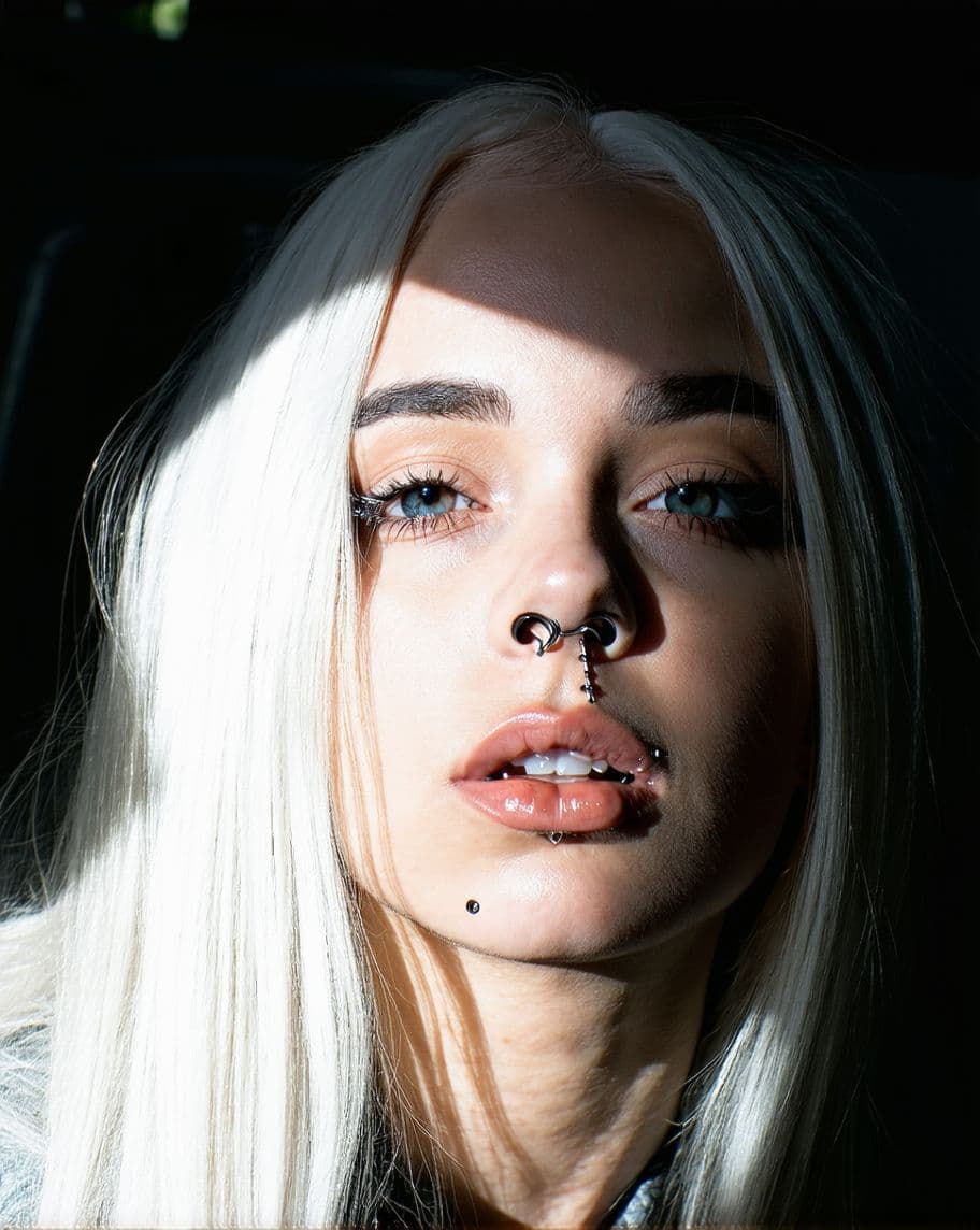 AI generated:  realistic close-up of a girl featuring white hair and piercings. Her lips are slightly parted, and ...