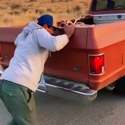 AI generated video: A man pushing a truck