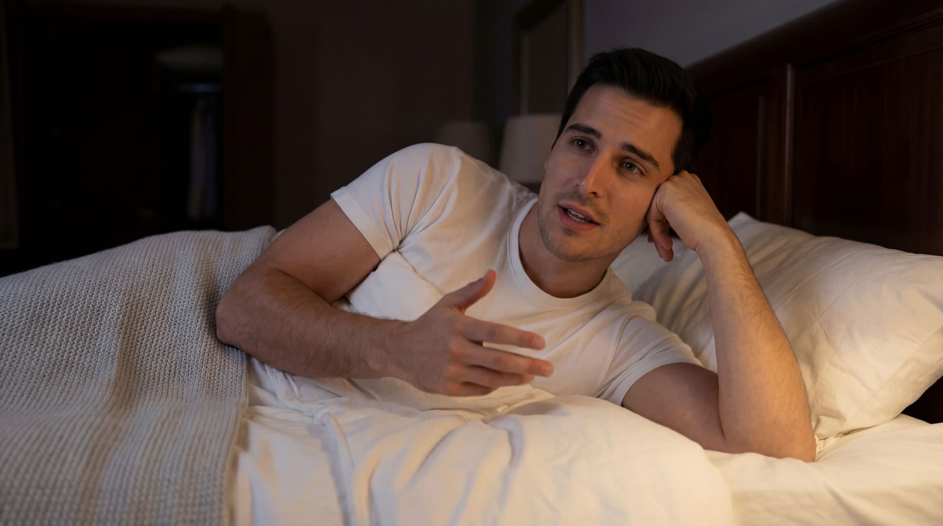 AI generated: The model is leaned on the bed on one hand, while expressing conversation with the other hand. 
